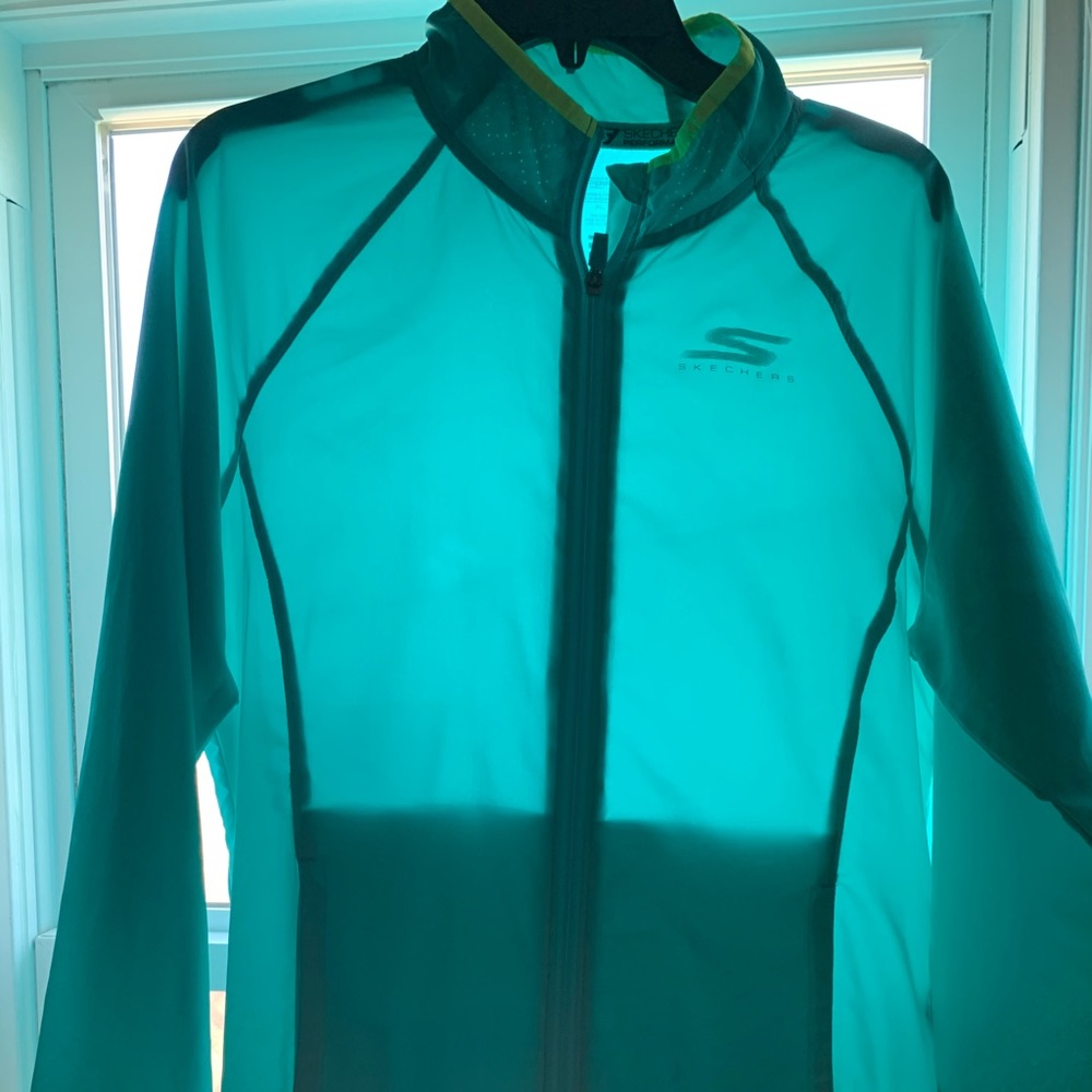 A green/blue windbreaker. Slightly used